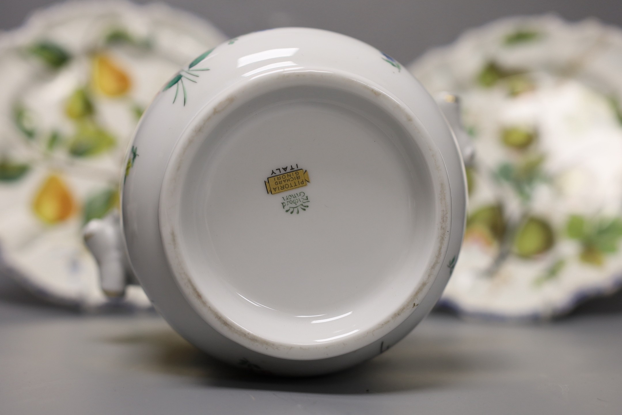 A pair of Meissen onion pattern candlesticks, 14 cm high, a Berlin figural salt, two Nove maiolica plates and a Richard Gingrich cache pot
